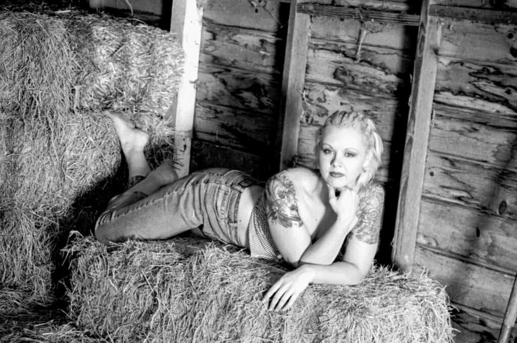 Rustic black and white boudoir portrait with tattoos and texture