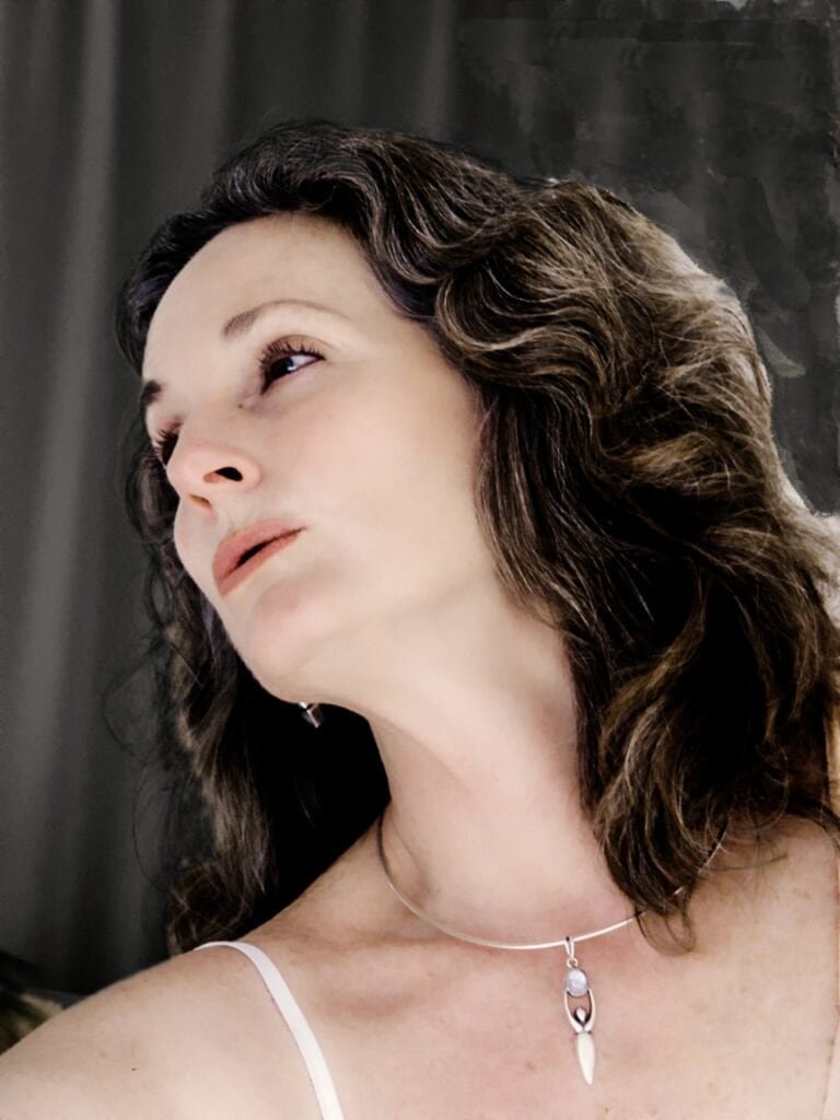 Fine art profile portrait of a woman looking upward in soft light